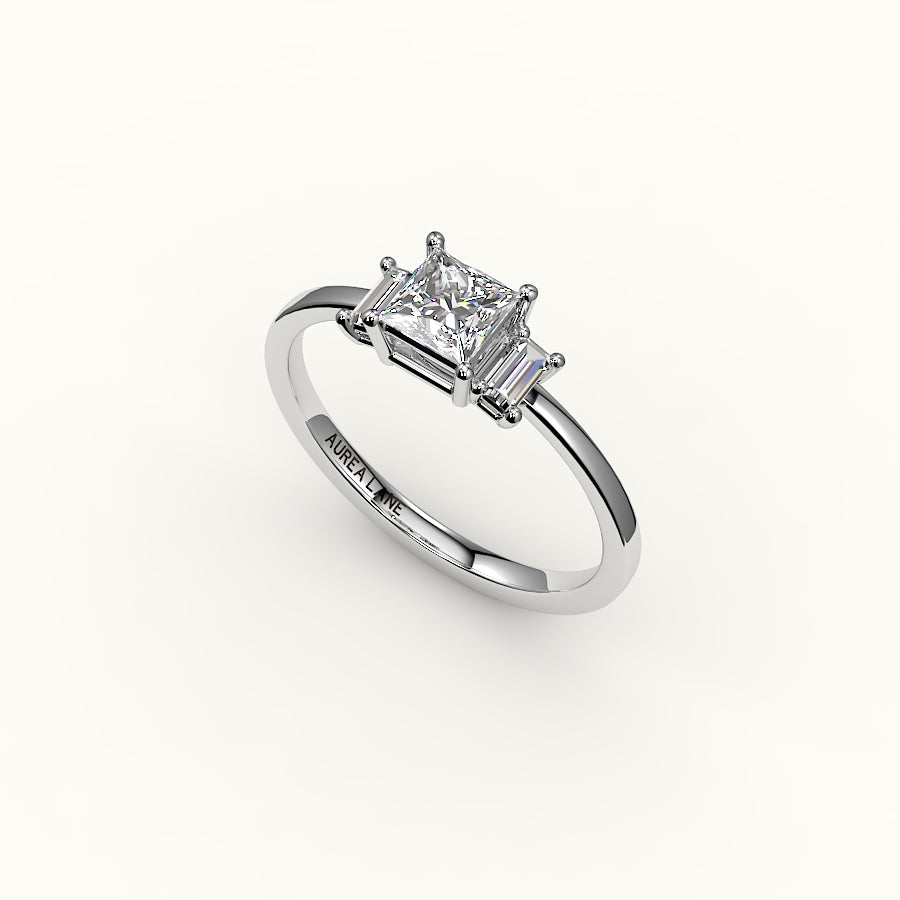 Engaste de tres piedras de corte princesa con baguettes verticales
