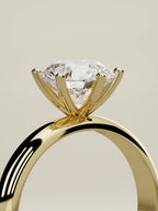 The Fina round lab-grown diamond solitaire in 14K yellow gold, standing three-quarter view