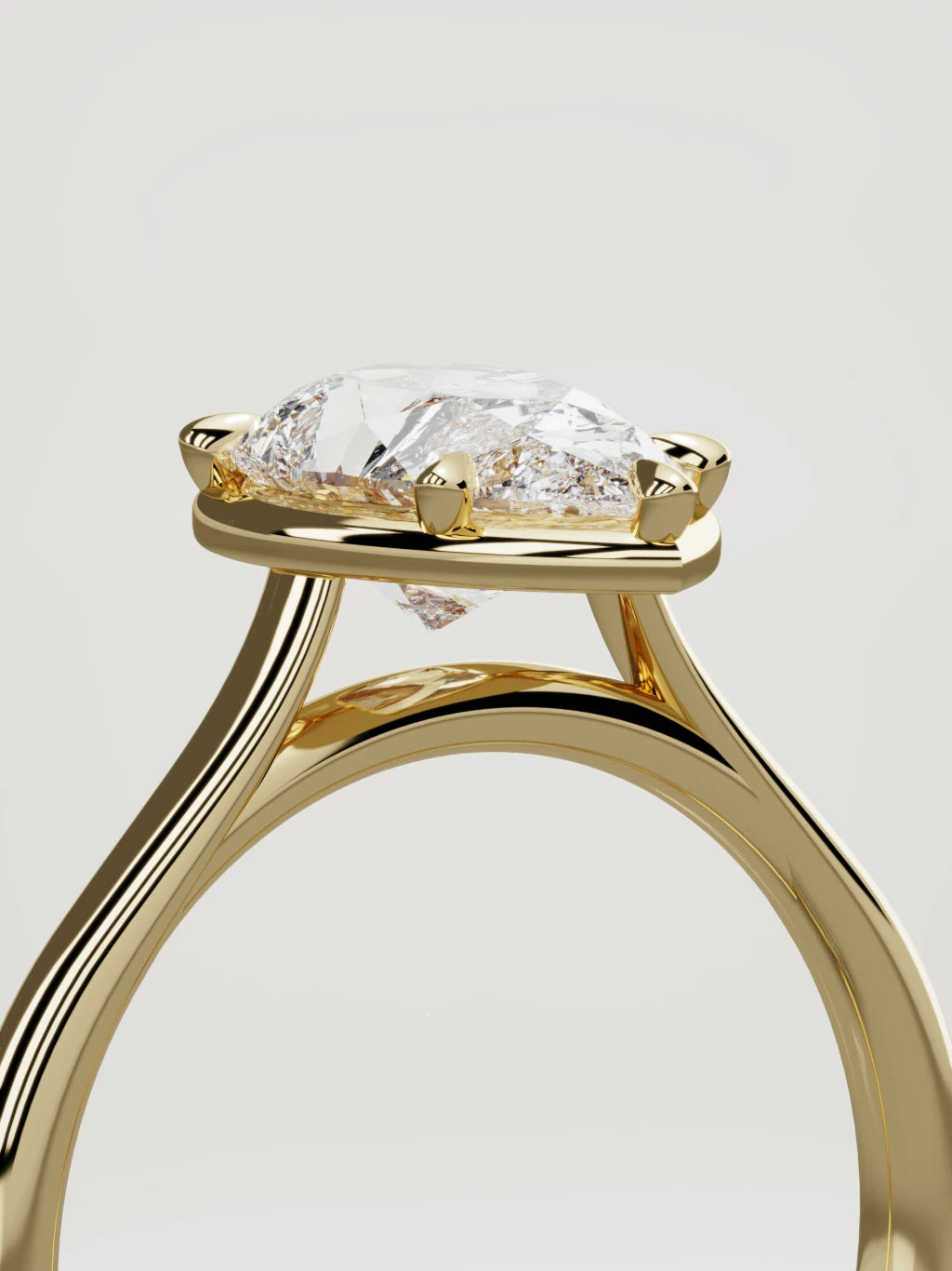 The Orbe pear-shaped lab-grown diamond solitaire in 14K yellow gold, standing three-quarter view