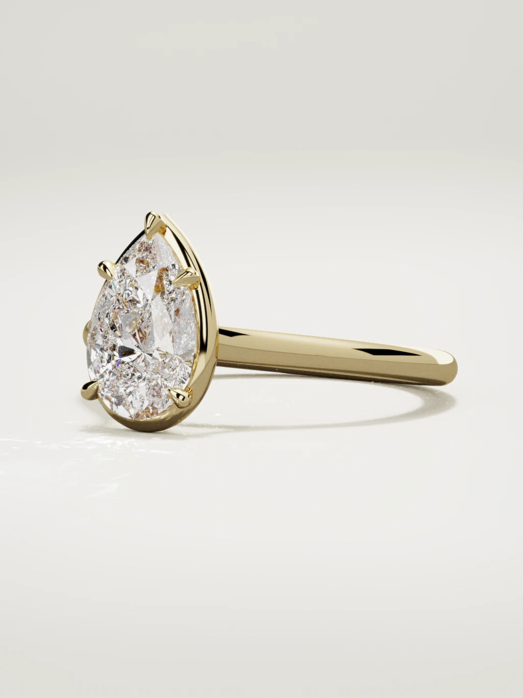 The Orbe pear-shaped lab-grown diamond solitaire in 14K yellow gold, three-quarter view