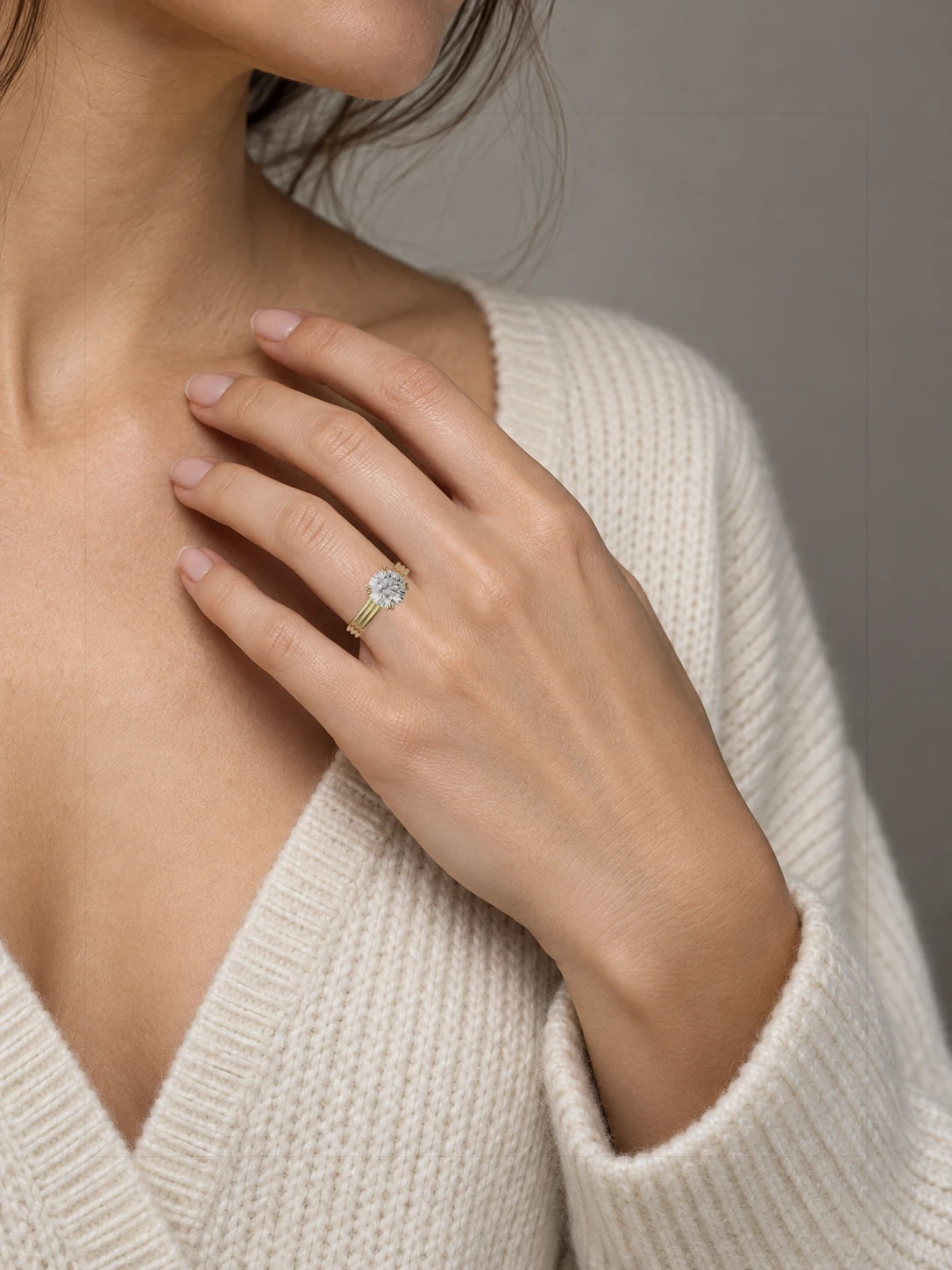 The Lira round lab-grown diamond solitaire in 14K yellow gold, on hand