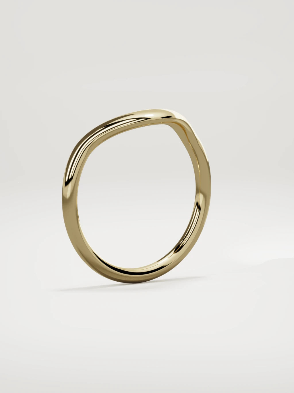 The Aria high contour wedding band in 14K yellow gold, standing three-quarter view