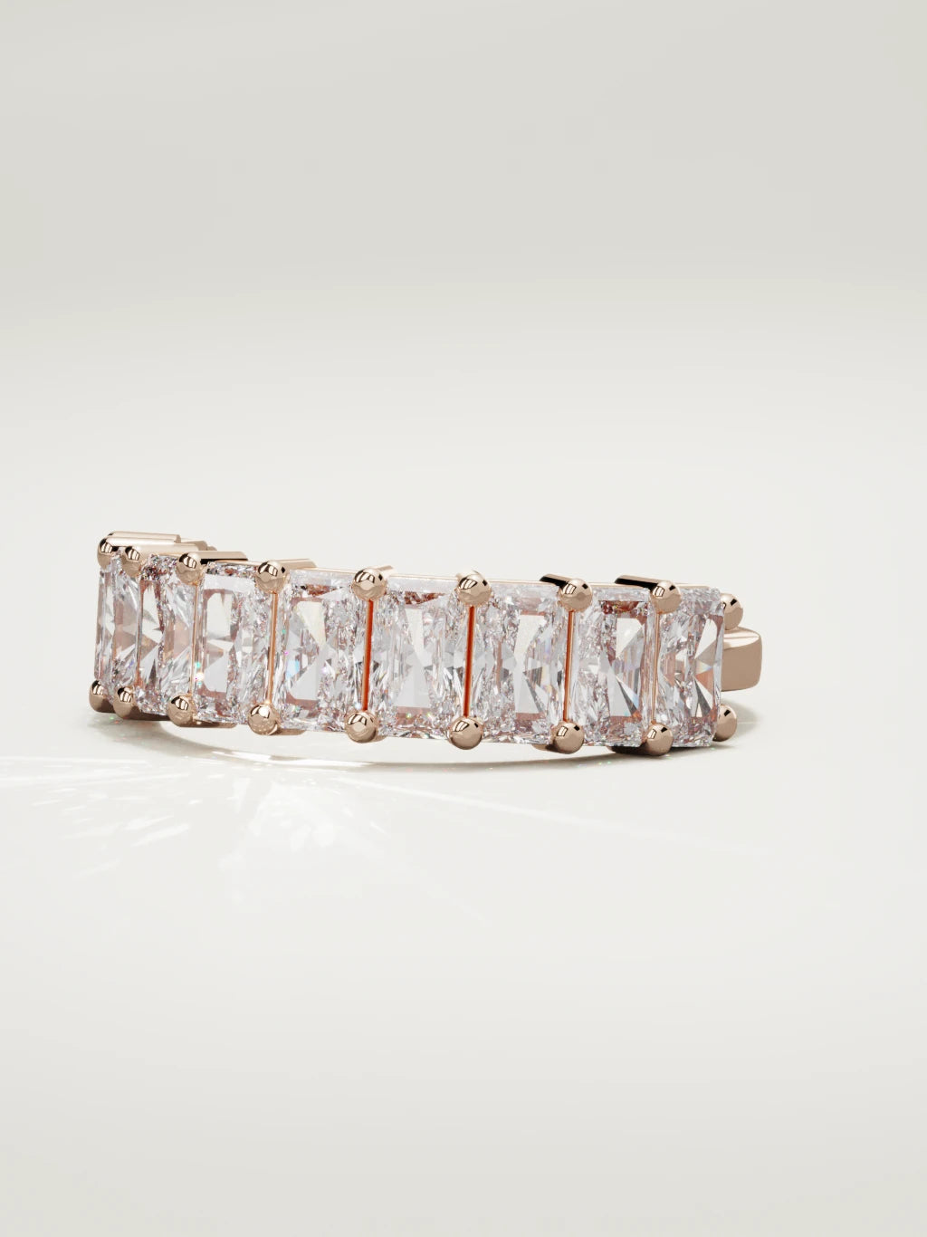 The Astra large prong radiant-cut half eternity band in 14K rose gold, three-quarter view