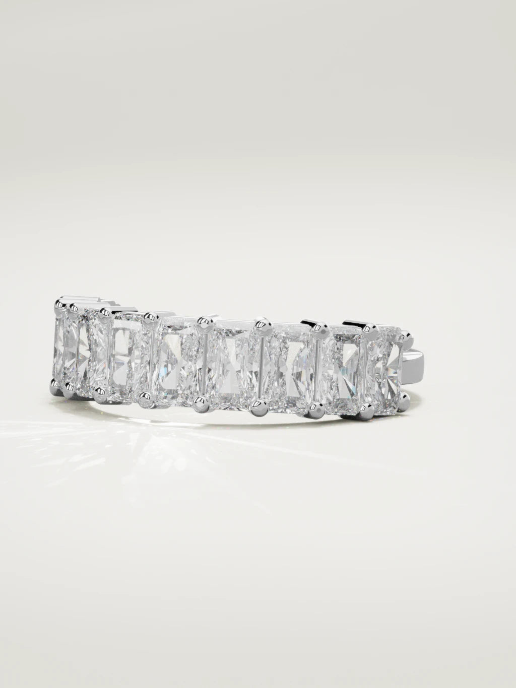 The Astra large prong radiant-cut half eternity band in 14K white gold, three-quarter view