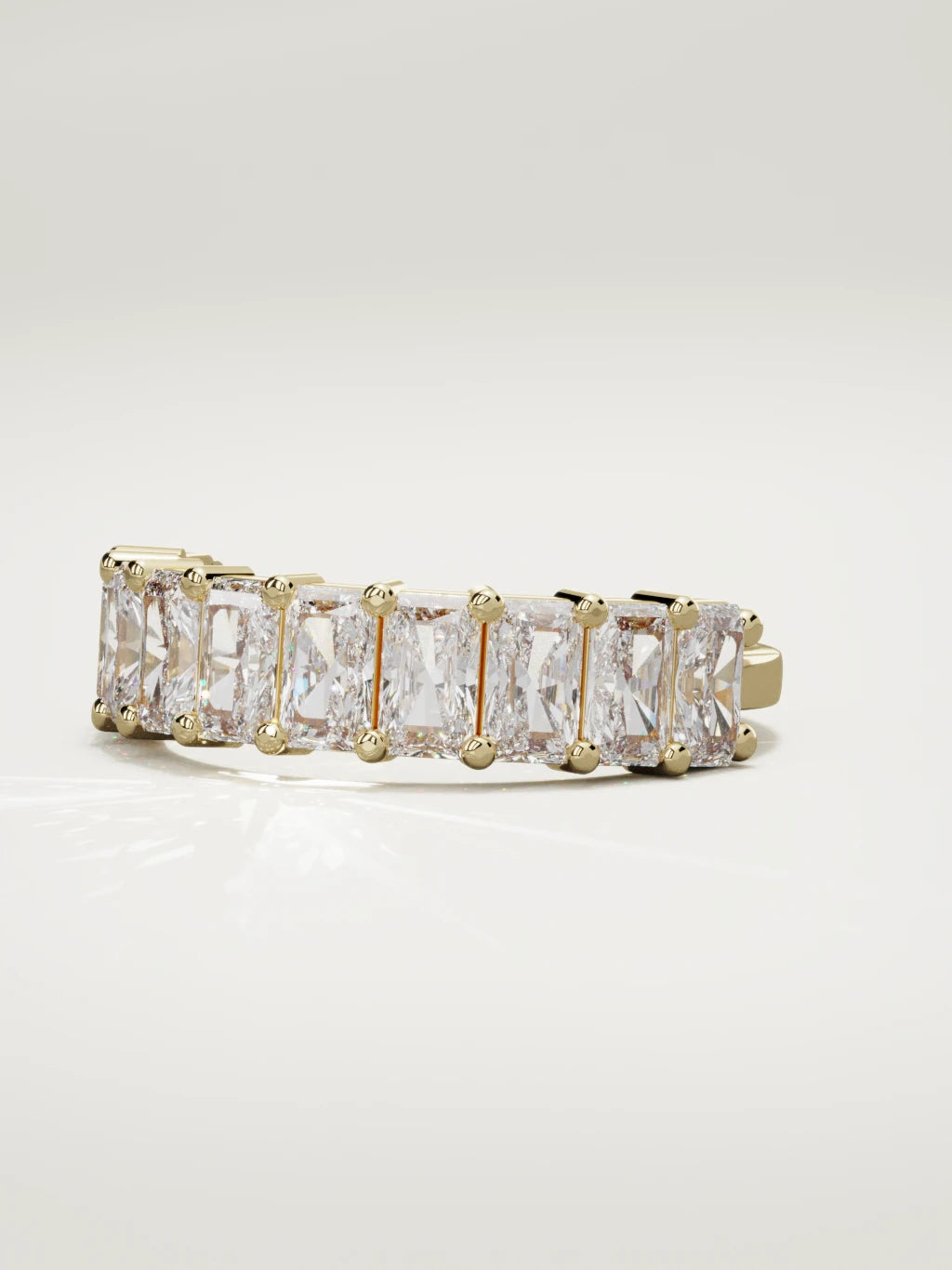 The Astra large prong radiant-cut half eternity band in 14K yellow gold, three-quarter view