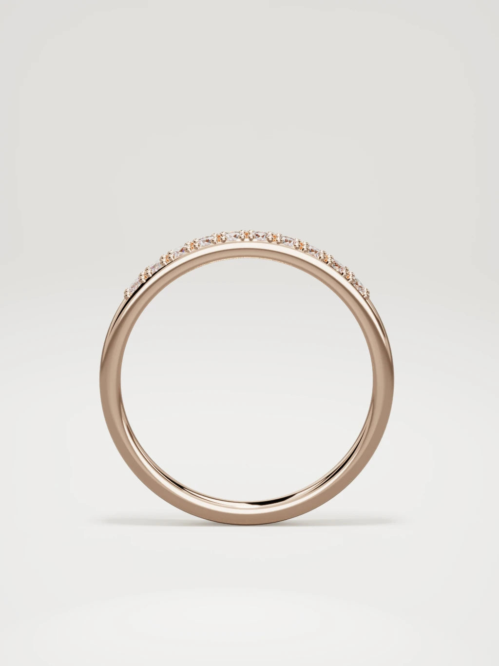 The Brisa petite half eternity band in 14K rose gold, standing front view