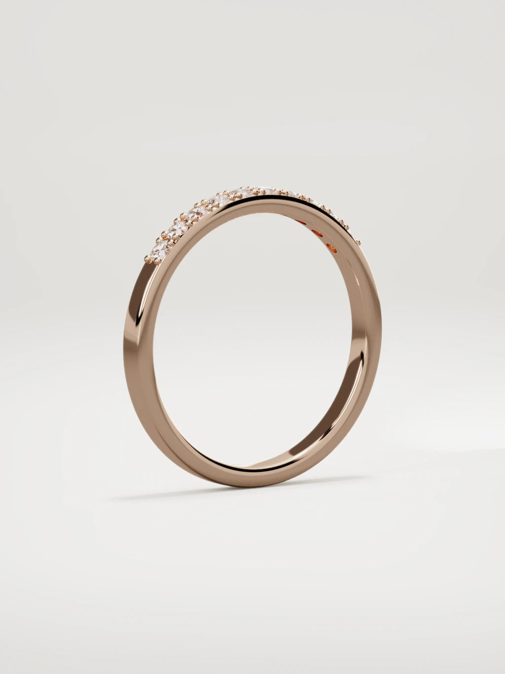 The Brisa petite half eternity band in 14K rose gold, standing three-quarter view