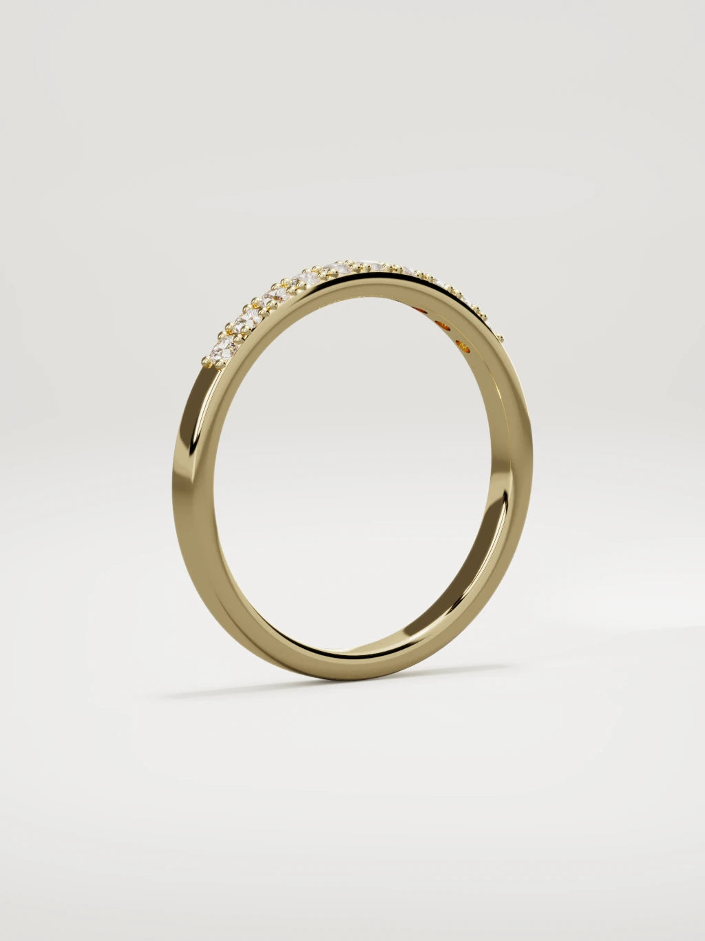 The Brisa petite half eternity band in 14K yellow gold, standing three-quarter view