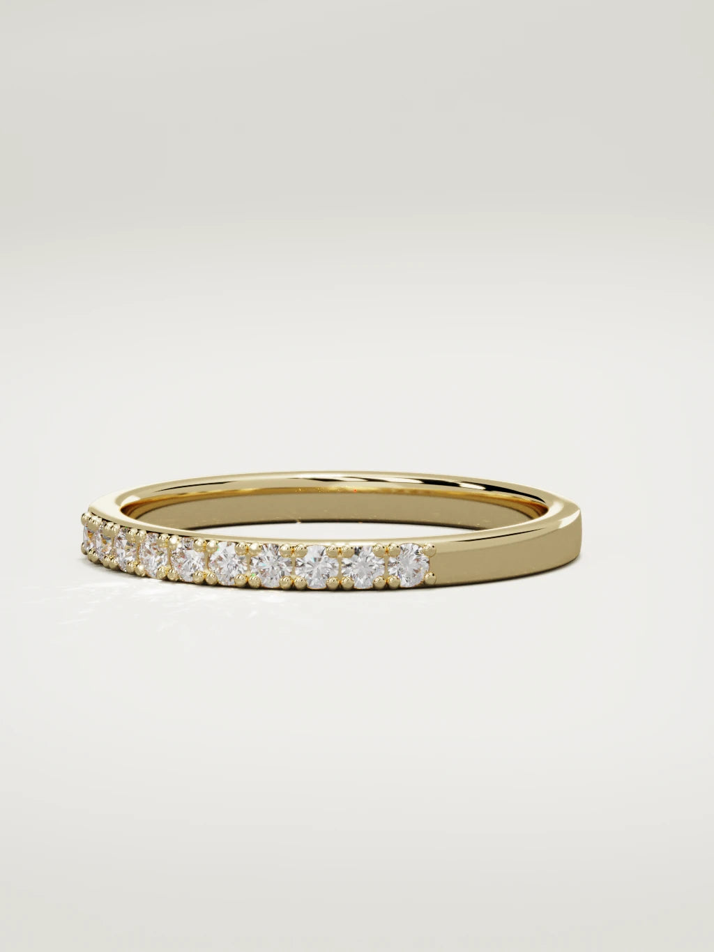 The Brisa petite half eternity band in 14K yellow gold, three-quarter view