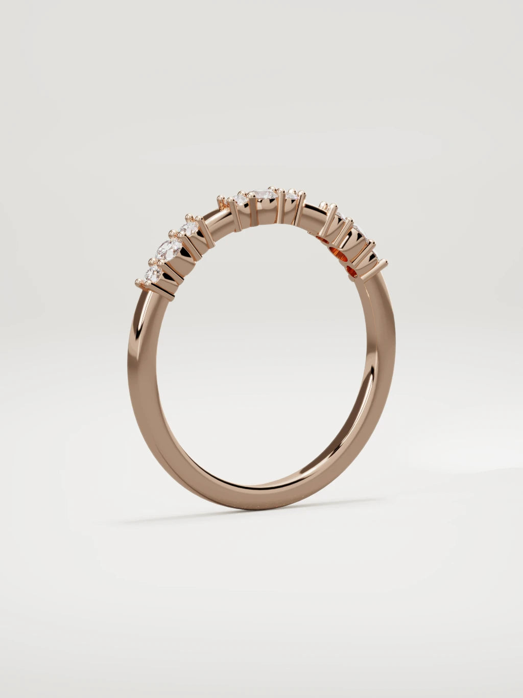 The Cielo scattered diamond band in 14K rose gold, standing three-quarter view