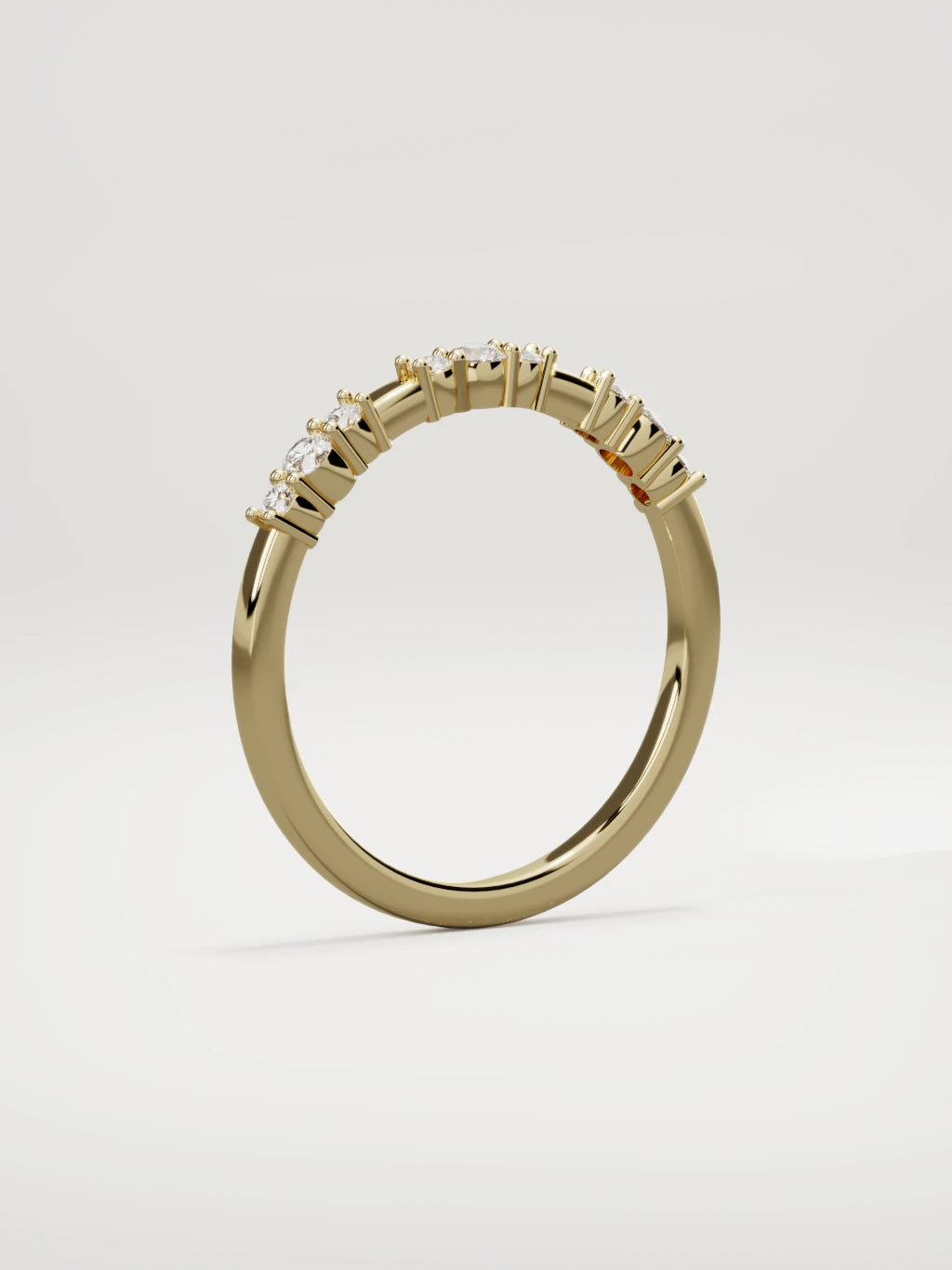 The Cielo scattered diamond band in 14K yellow gold, standing three-quarter view