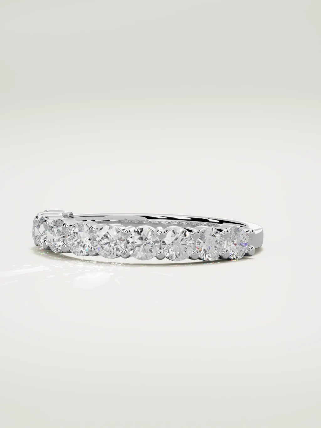 The Clara shared-prong half eternity band in 14K white gold, three-quarter view