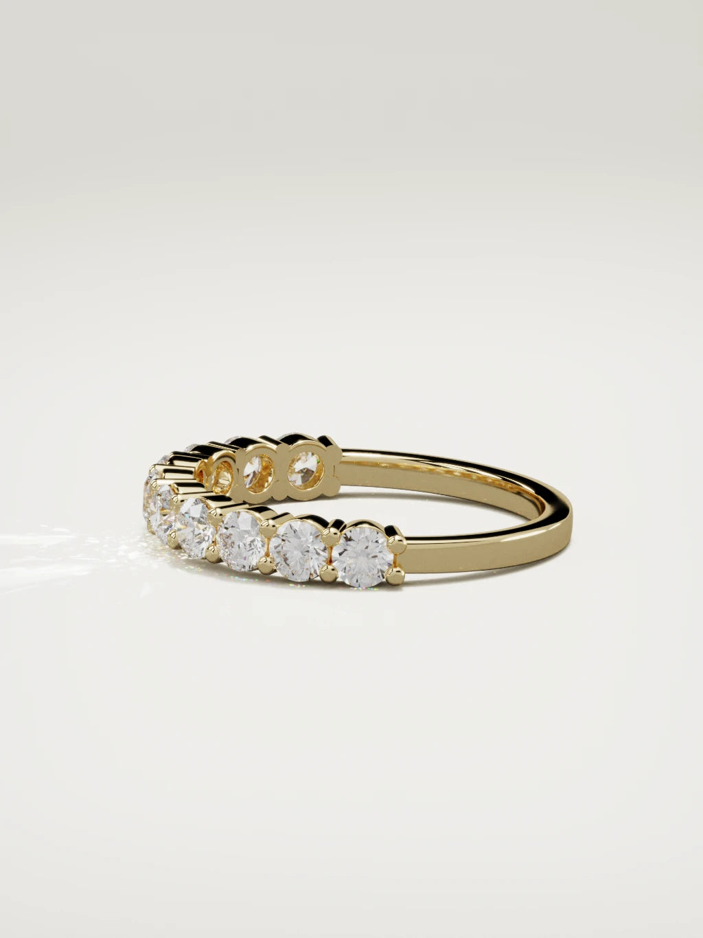 The Clara shared-prong half eternity band in 14K yellow gold, side view