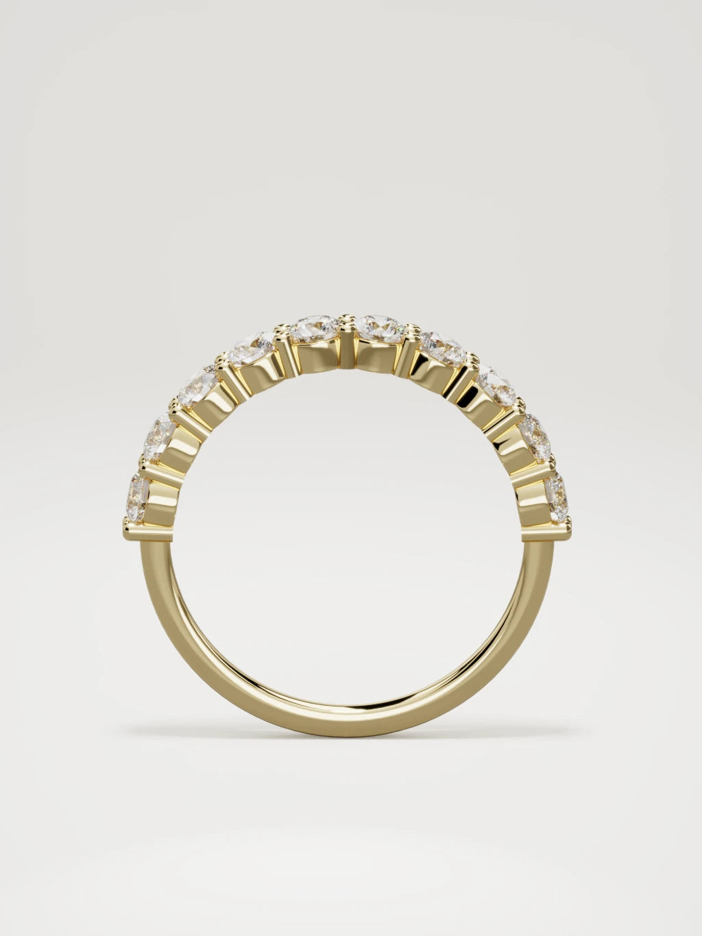 The Clara shared-prong half eternity band in 14K yellow gold, standing front view