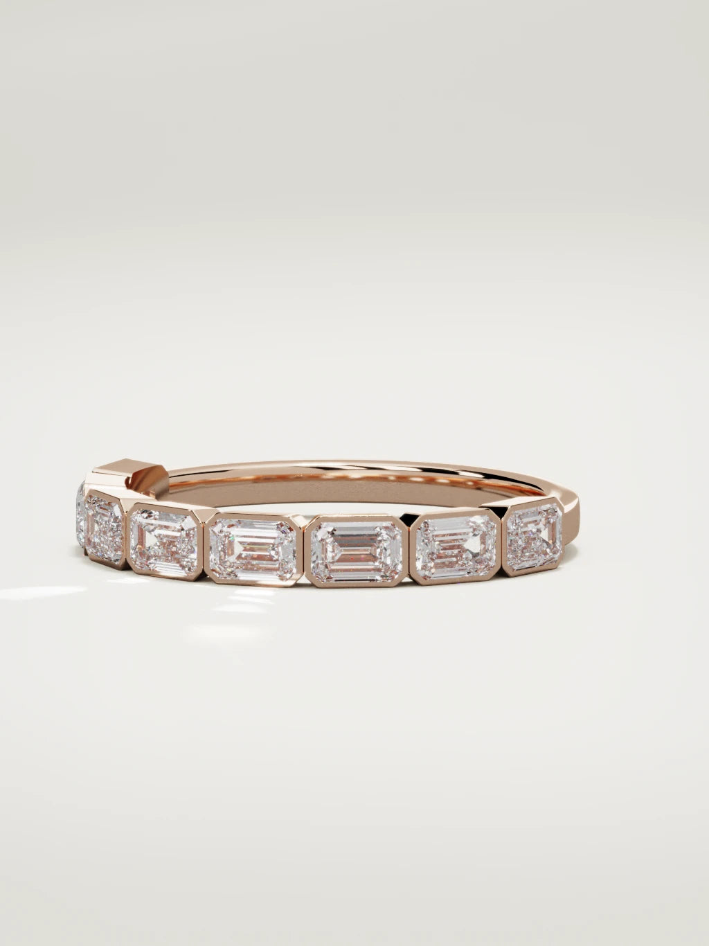 The Cristal east-west bezel emerald-cut band in 14K rose gold, three-quarter view