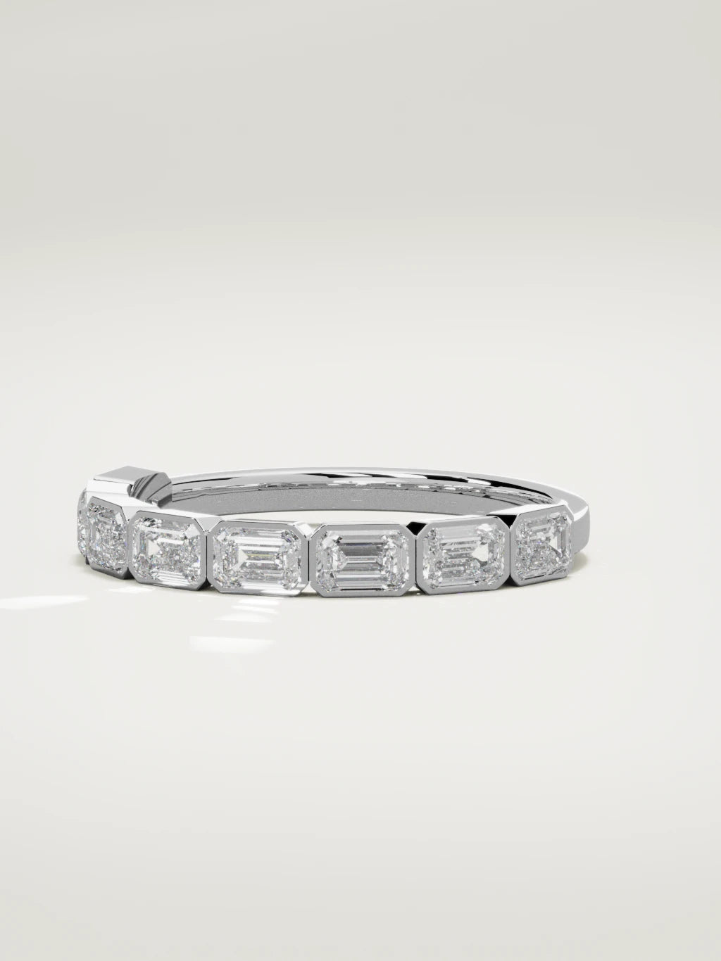The Cristal east-west bezel emerald-cut band in 14K white gold, three-quarter view