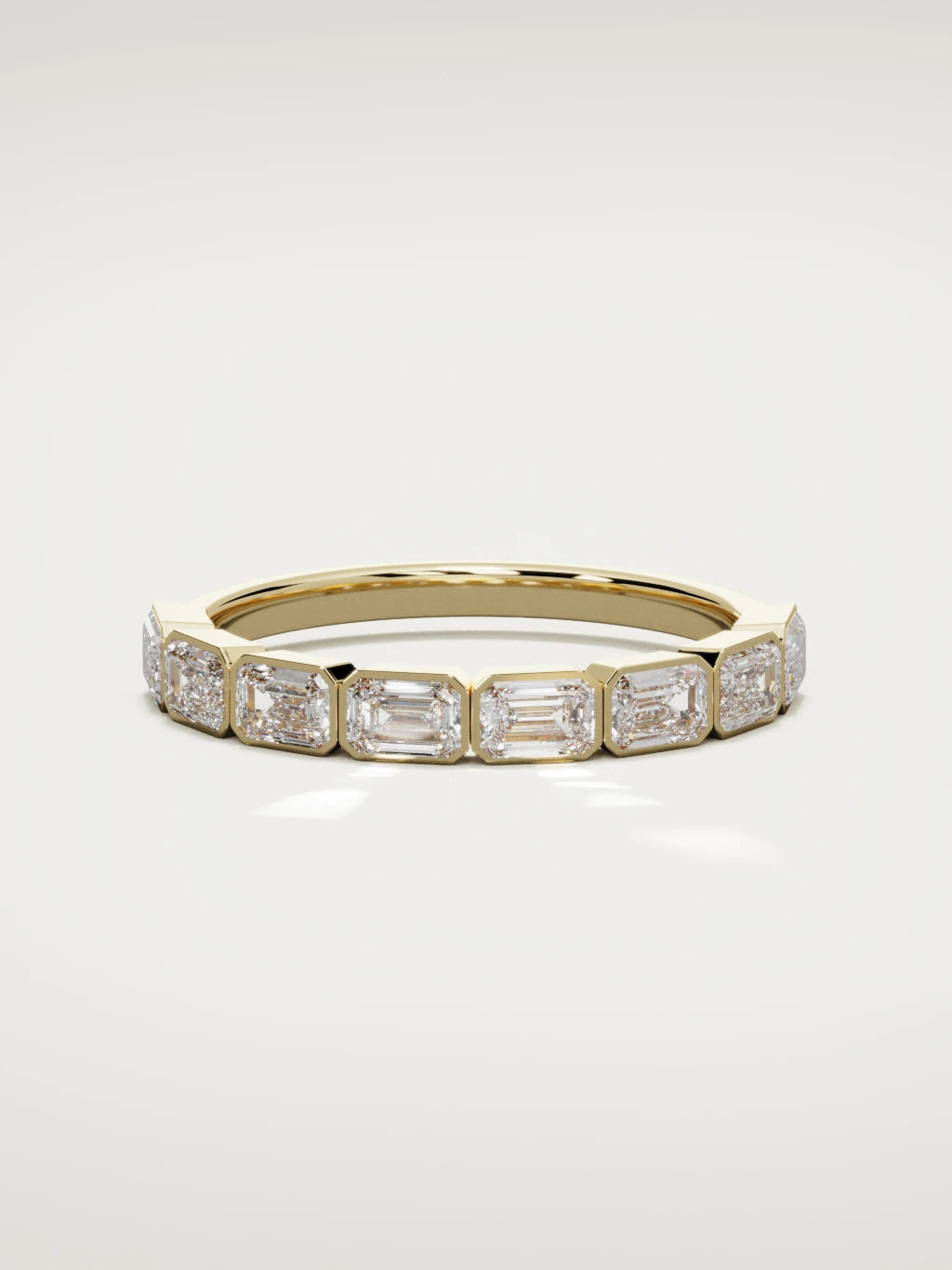 The Cristal east-west bezel emerald-cut band in 14K yellow gold, front view