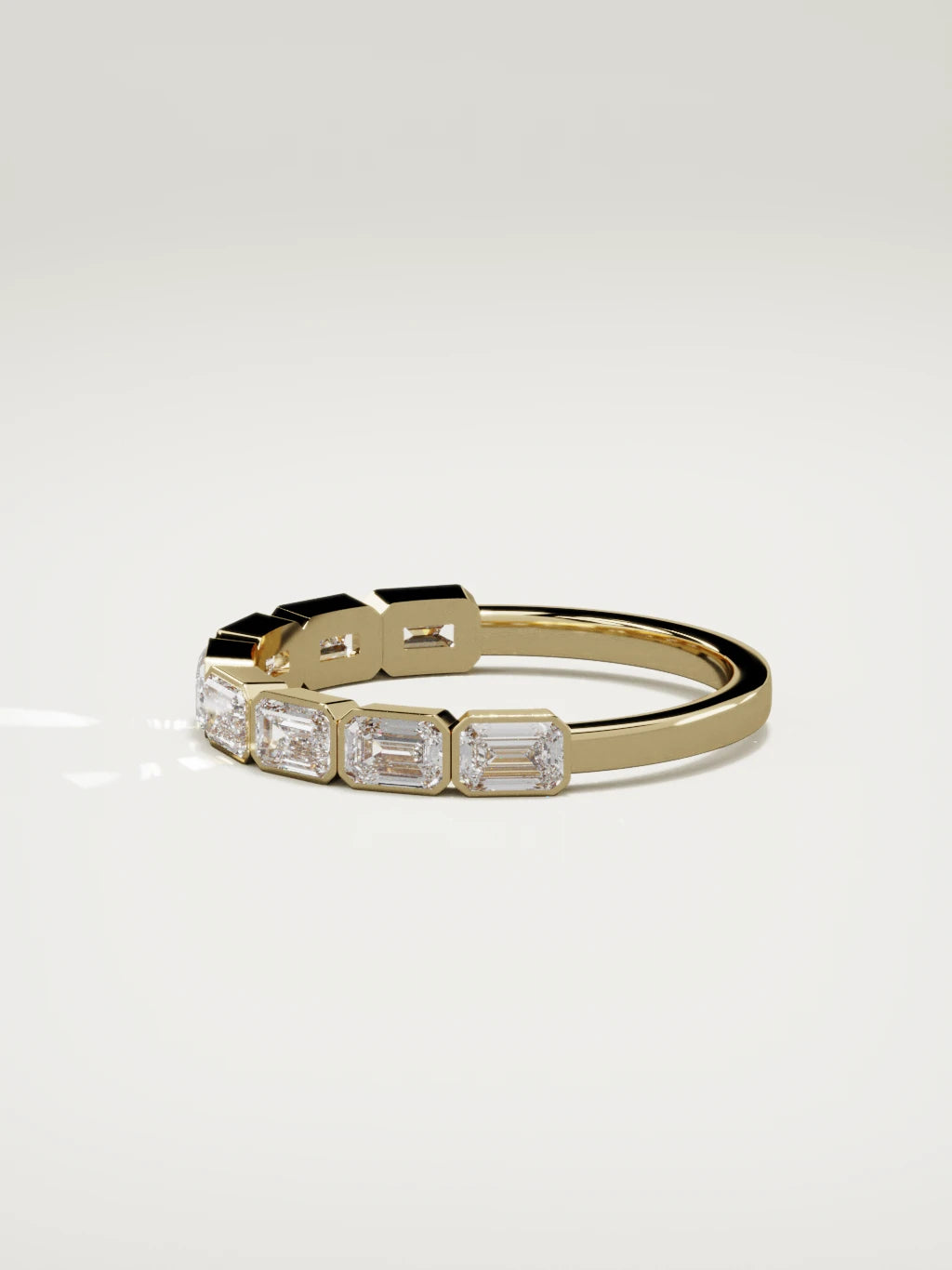 The Cristal east-west bezel emerald-cut band in 14K yellow gold, side view
