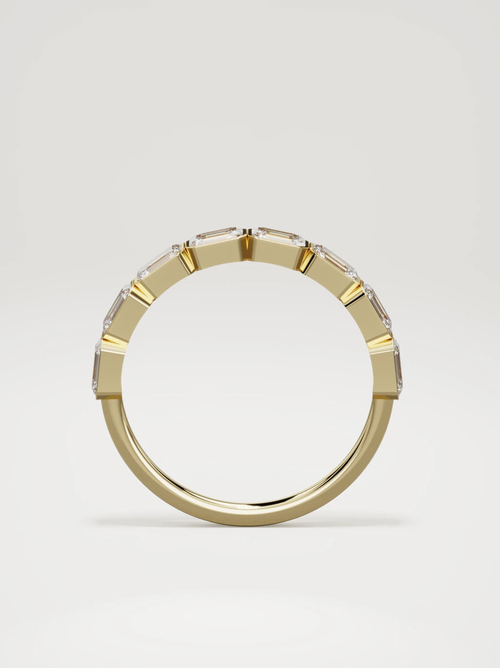 The Cristal east-west bezel emerald-cut band in 14K yellow gold, standing front view