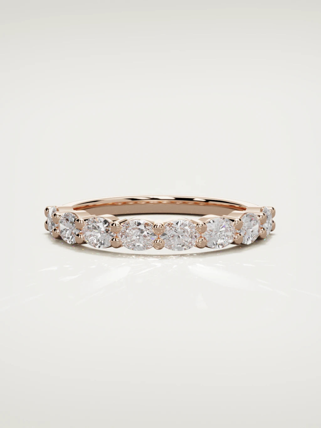 The Dama east-west oval half eternity band in 14K rose gold, front view