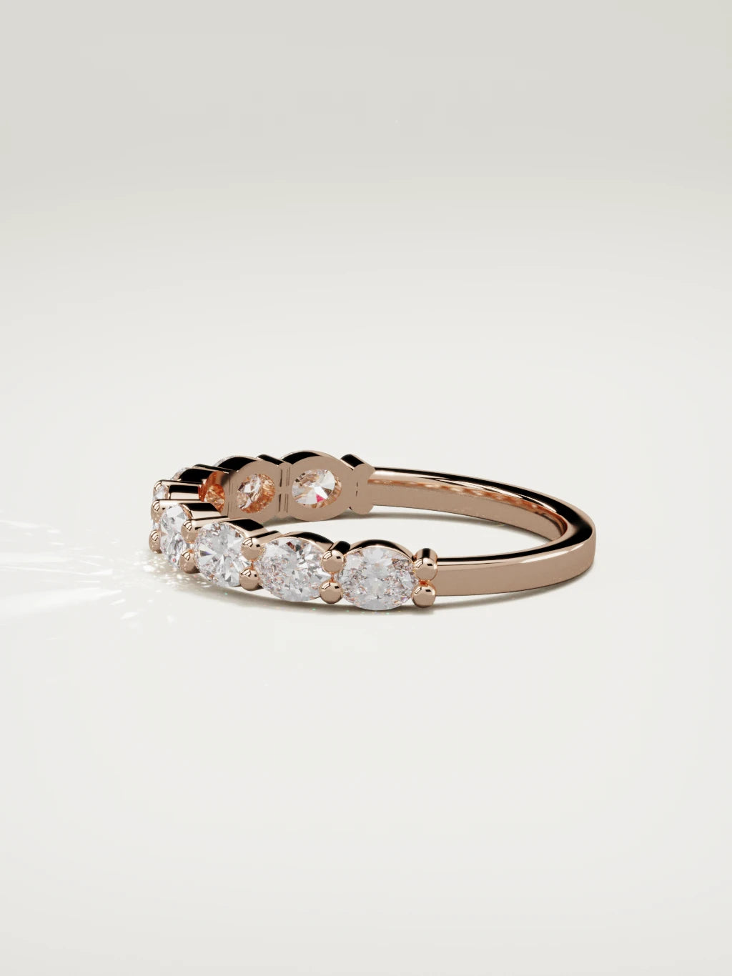 The Dama east-west oval half eternity band in 14K rose gold, side view
