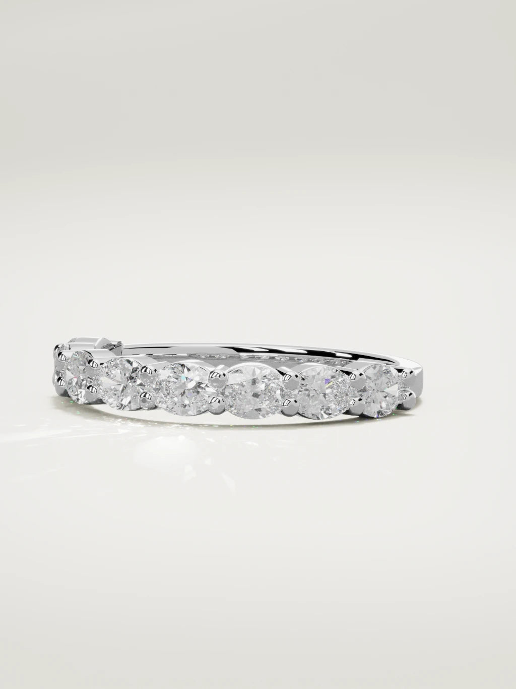 The Dama east-west oval half eternity band in 14K white gold, three-quarter view