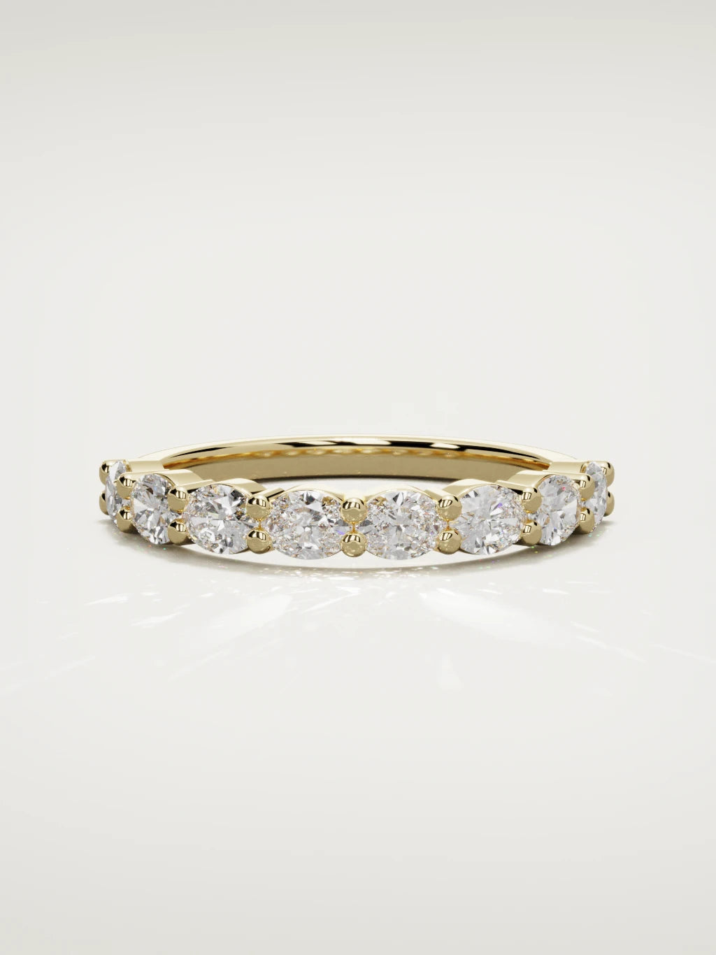 The Dama east-west oval half eternity band in 14K yellow gold, front view
