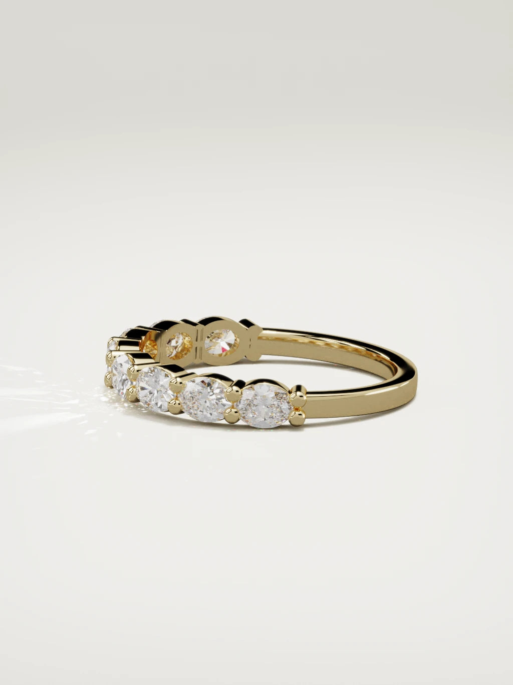 The Dama east-west oval half eternity band in 14K yellow gold, side view