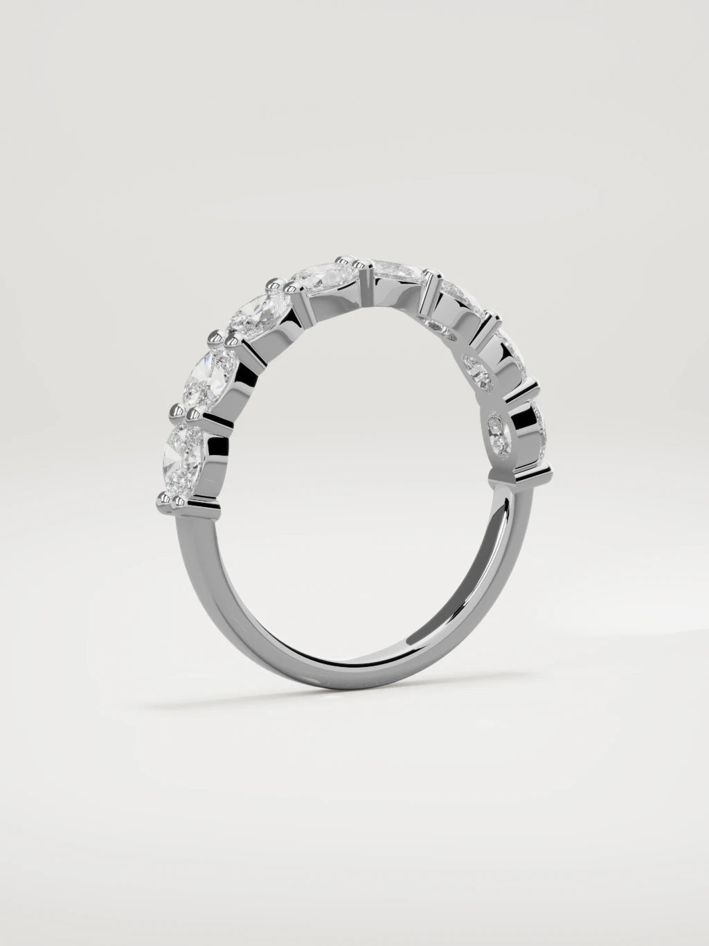 The Dama east-west oval half eternity band in 14K white gold, standing three-quarter view