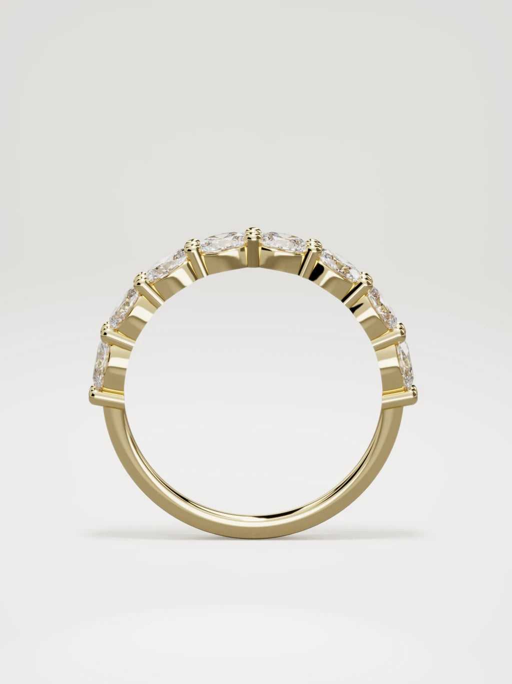 The Dama east-west oval half eternity band in 14K yellow gold, standing front view