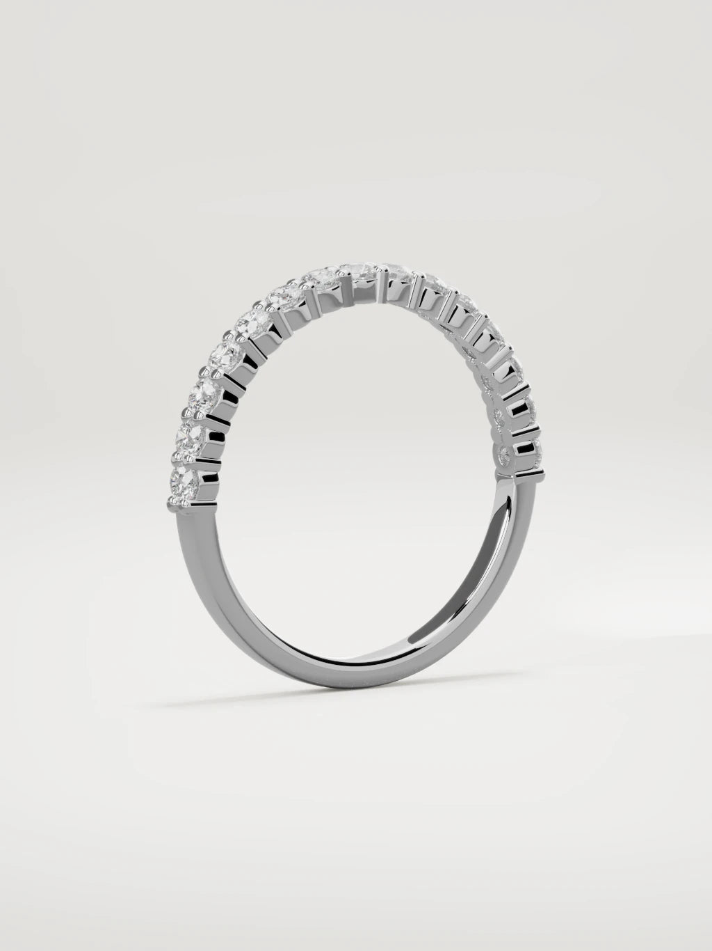 The Danza petite shared-prong half eternity band in 14K white gold, standing three-quarter view