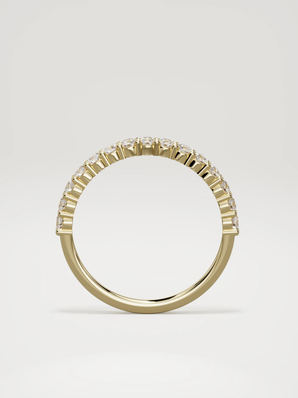 The Danza petite shared-prong half eternity band in 14K yellow gold, standing front view