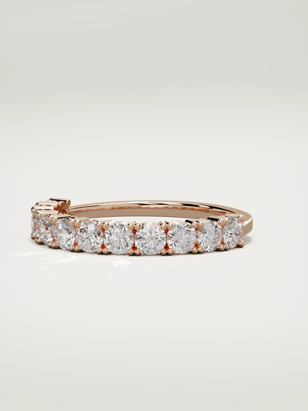 The Gloria open-prong half eternity band in 14K rose gold, three-quarter view