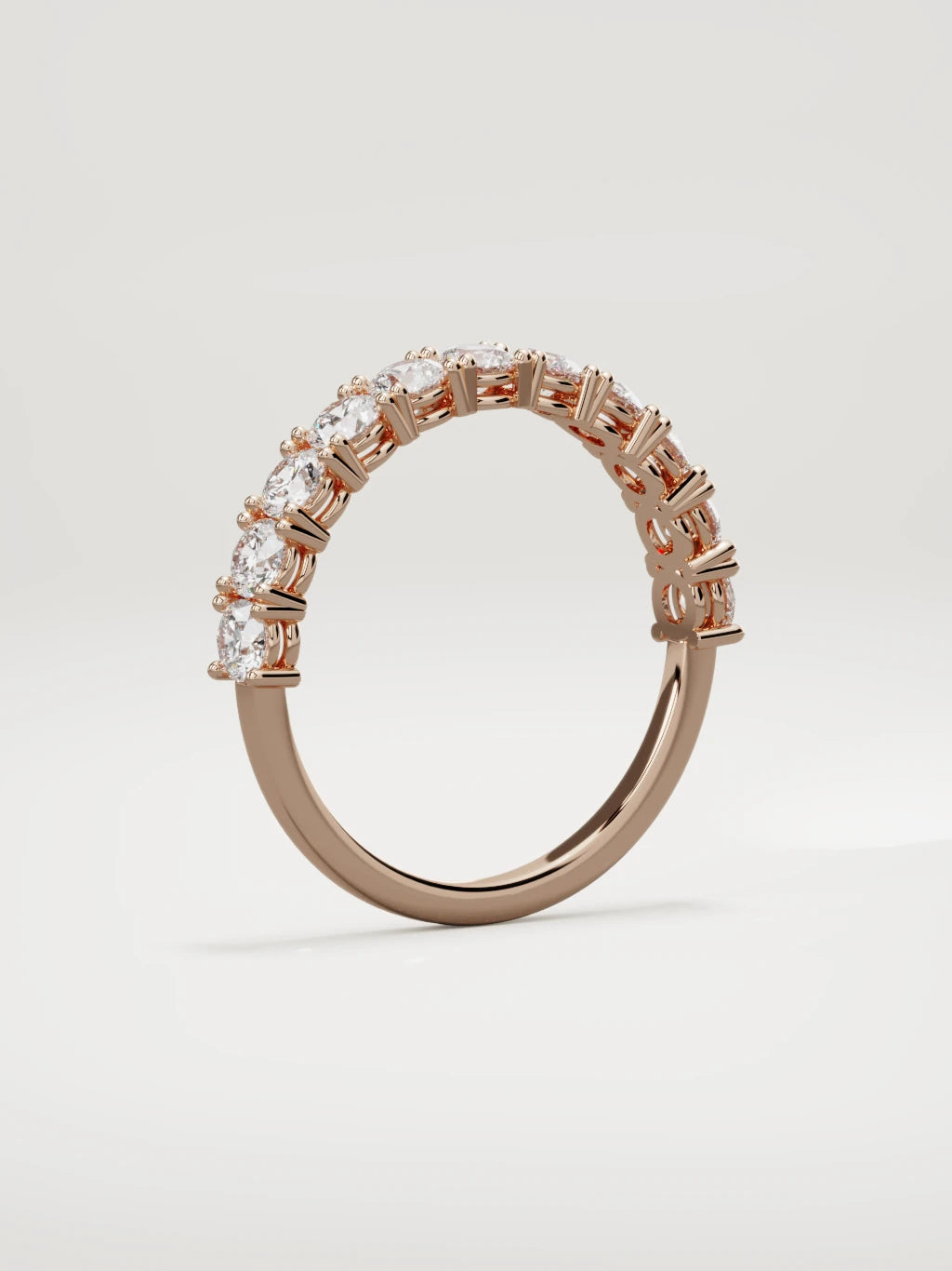 The Gloria open-prong half eternity band in 14K rose gold, standing three-quarter view