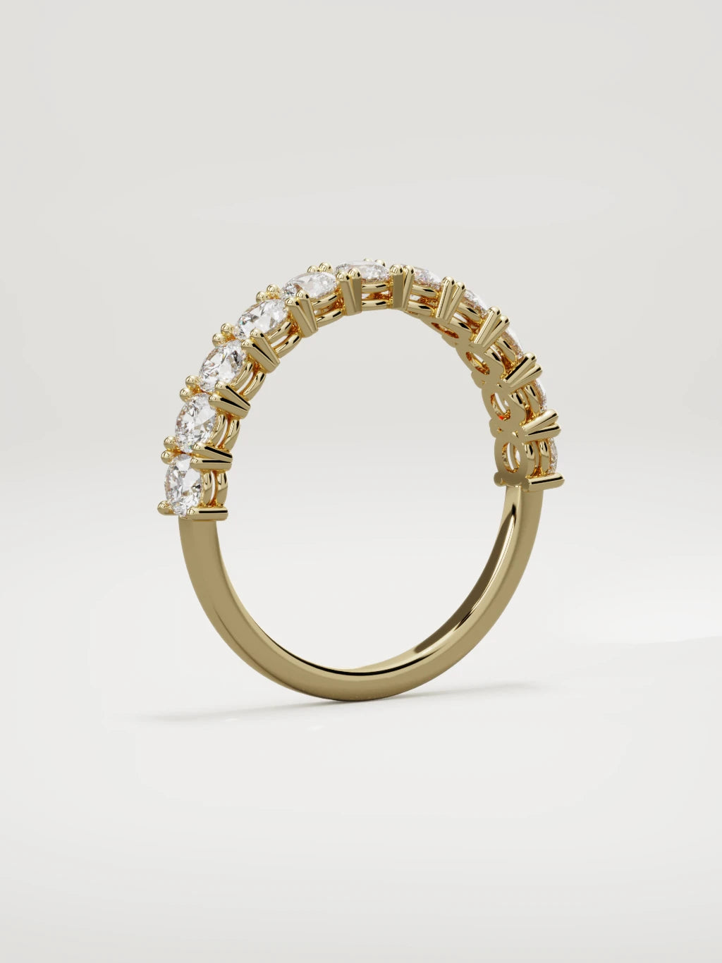 The Gloria open-prong half eternity band in 14K yellow gold, standing three-quarter view