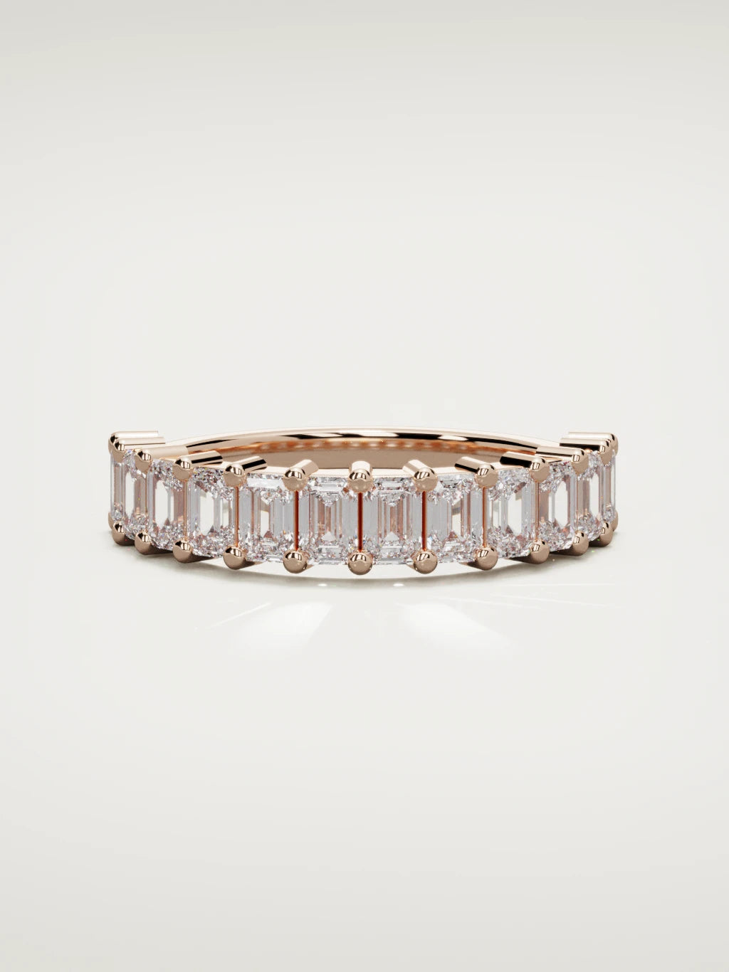 The Gracia prong emerald-cut half eternity band in 14K rose gold, front view