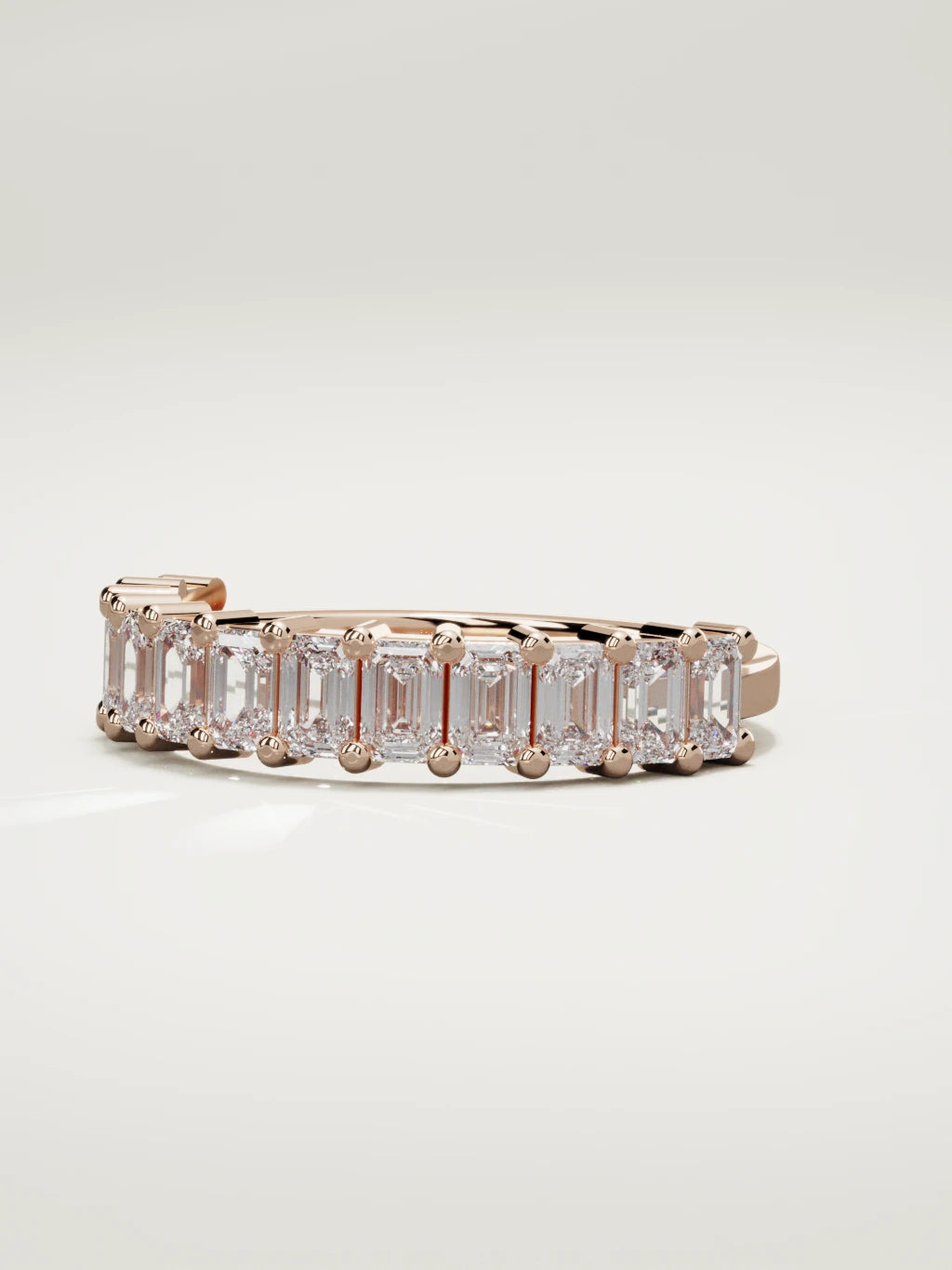 The Gracia prong emerald-cut half eternity band in 14K rose gold, three-quarter view