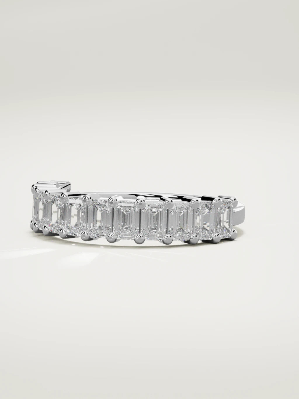 The Gracia prong emerald-cut half eternity band in 14K white gold, three-quarter view