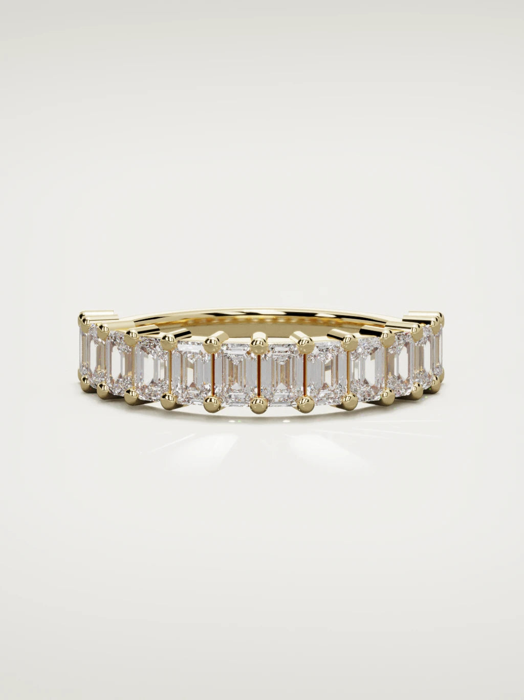The Gracia prong emerald-cut half eternity band in 14K yellow gold, front view