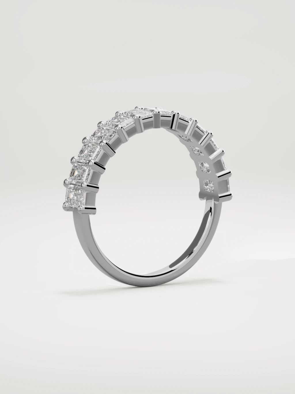 The Gracia prong emerald-cut half eternity band in 14K white gold, standing three-quarter view