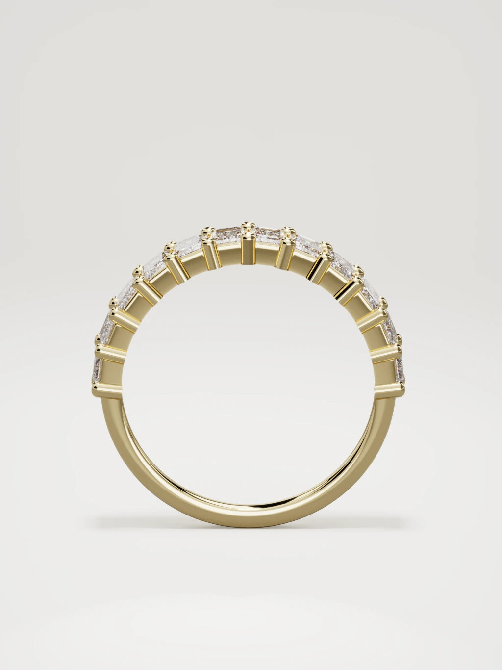The Gracia prong emerald-cut half eternity band in 14K yellow gold, standing front view