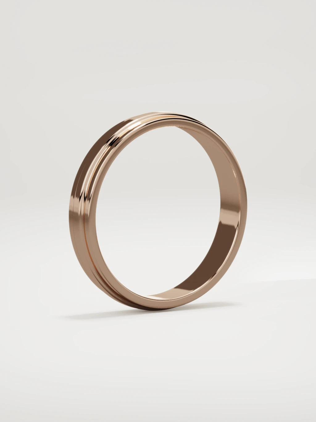 The Linea center-ridge men's wedding band in 14K rose gold, 4 mm, standing three-quarter view