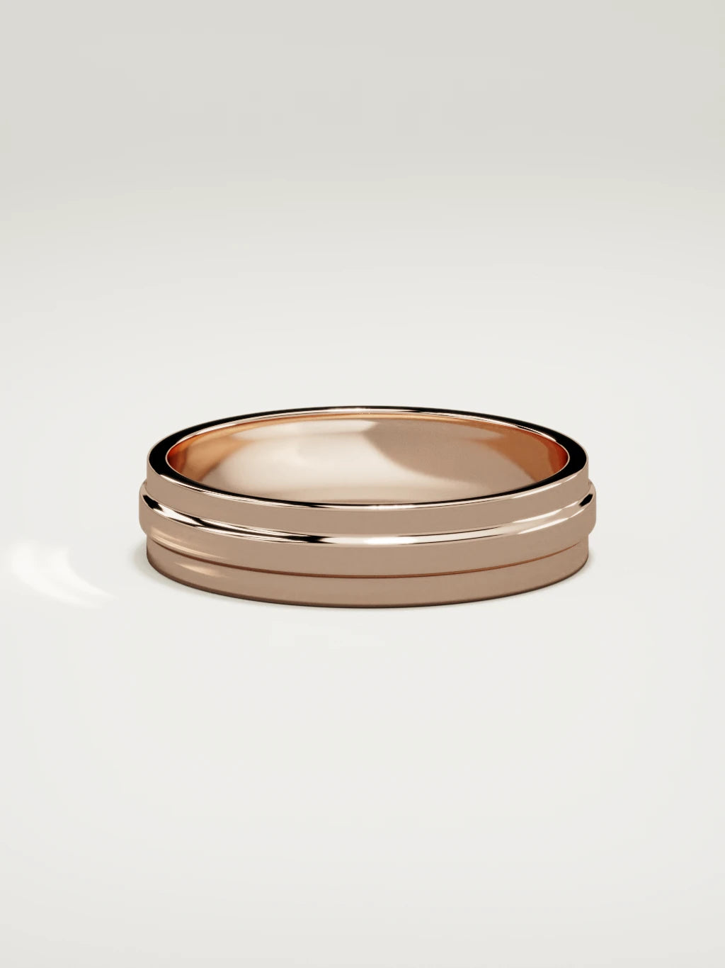 The Linea center-ridge men's wedding band in 14K rose gold, 5 mm, side view