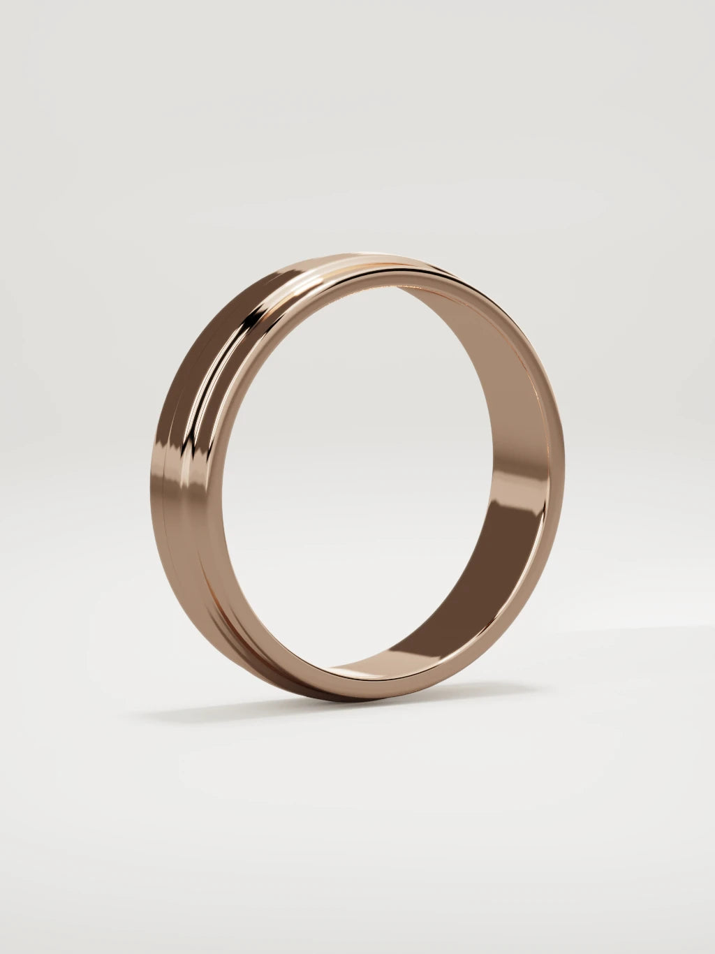The Linea center-ridge men's wedding band in 14K rose gold, 5 mm, standing three-quarter view