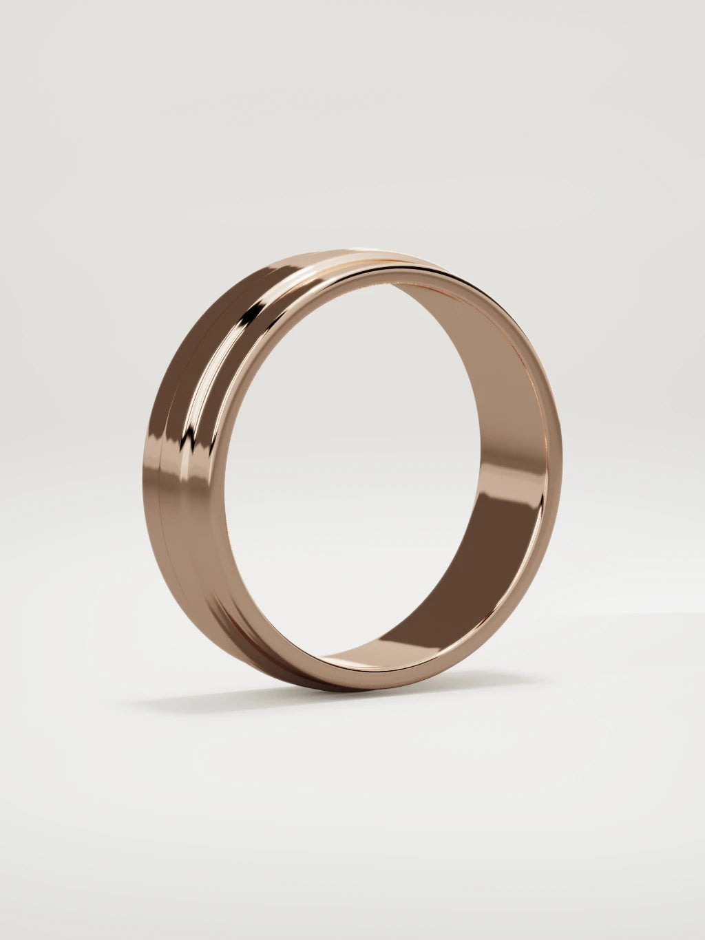 The Linea center-ridge men's wedding band in 14K rose gold, 6 mm, standing three-quarter view