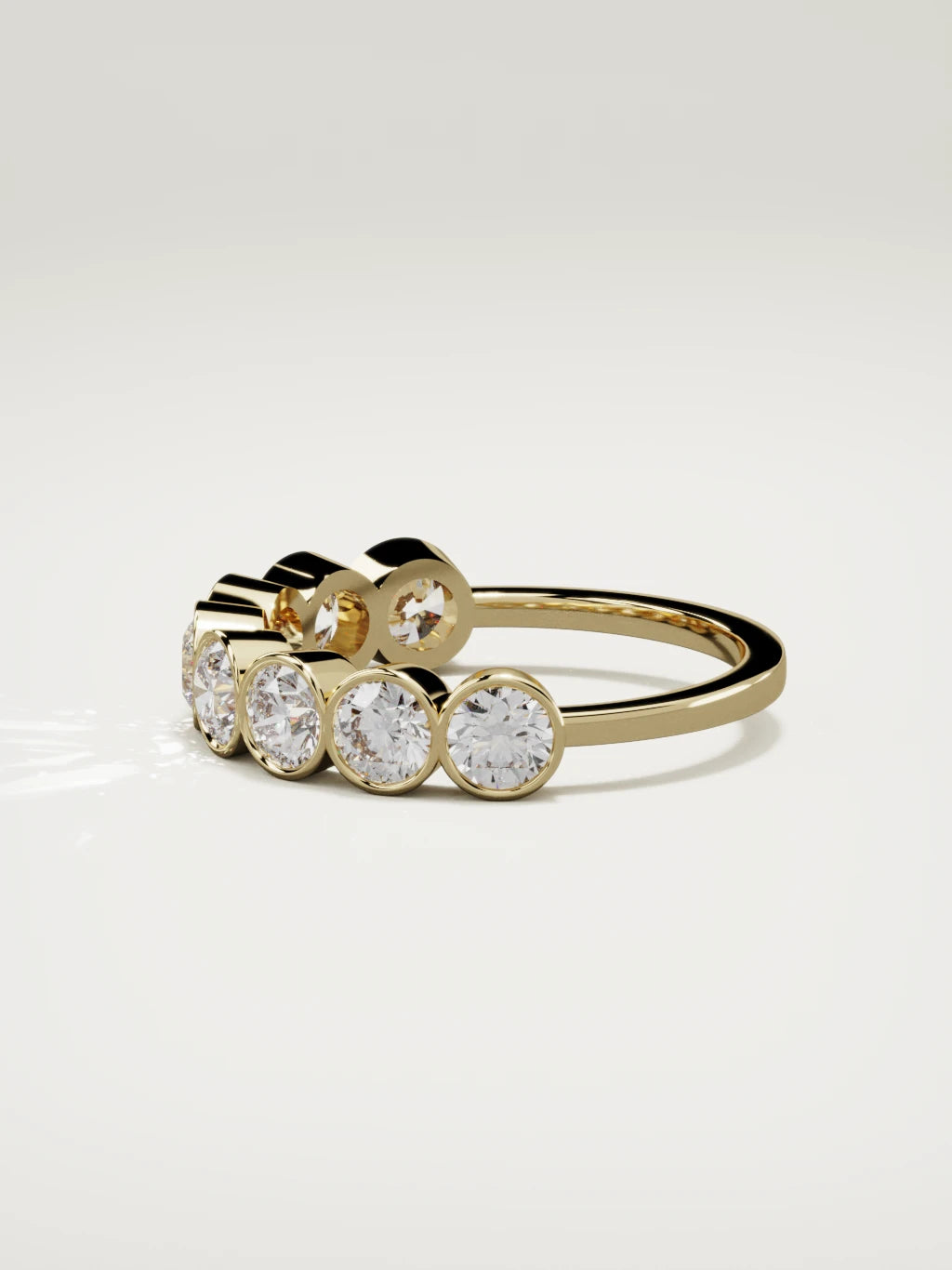The Lumen large bezel bubble half eternity band in 14K yellow gold, side view