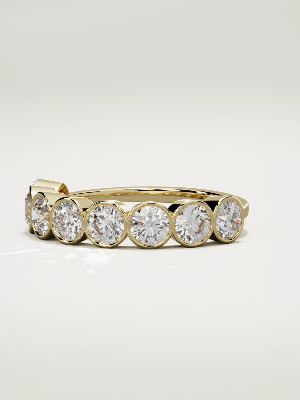 The Lumen large bezel bubble half eternity band in 14K yellow gold, three-quarter view