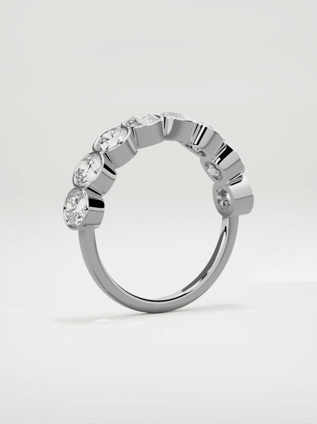 The Lumen large bezel bubble half eternity band in 14K white gold, standing three-quarter view