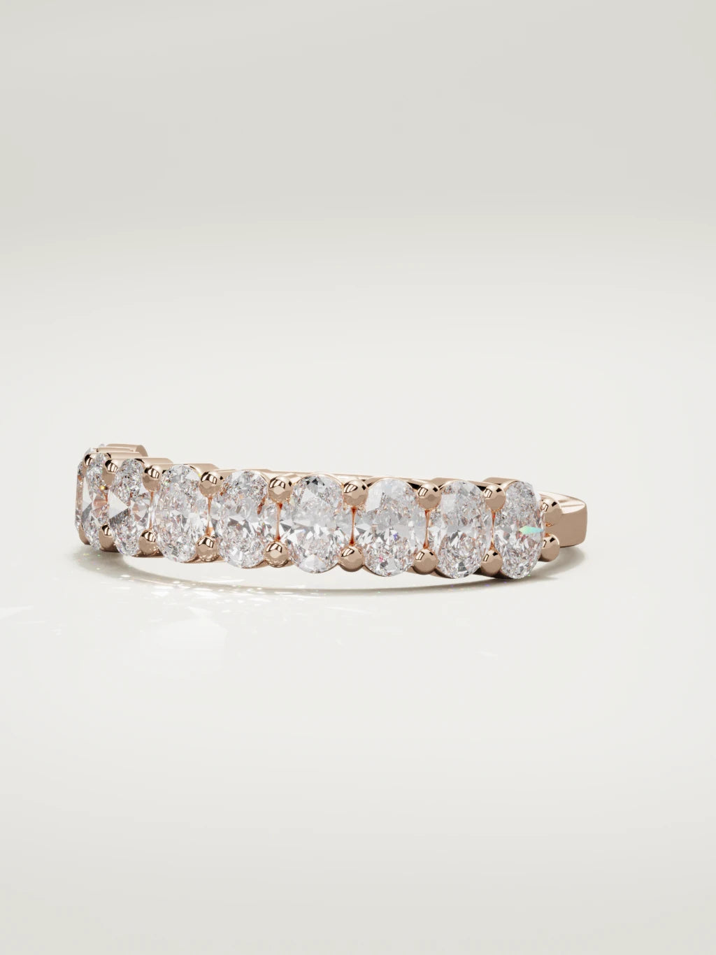 The Musa north-south oval half eternity band in 14K rose gold, three-quarter view