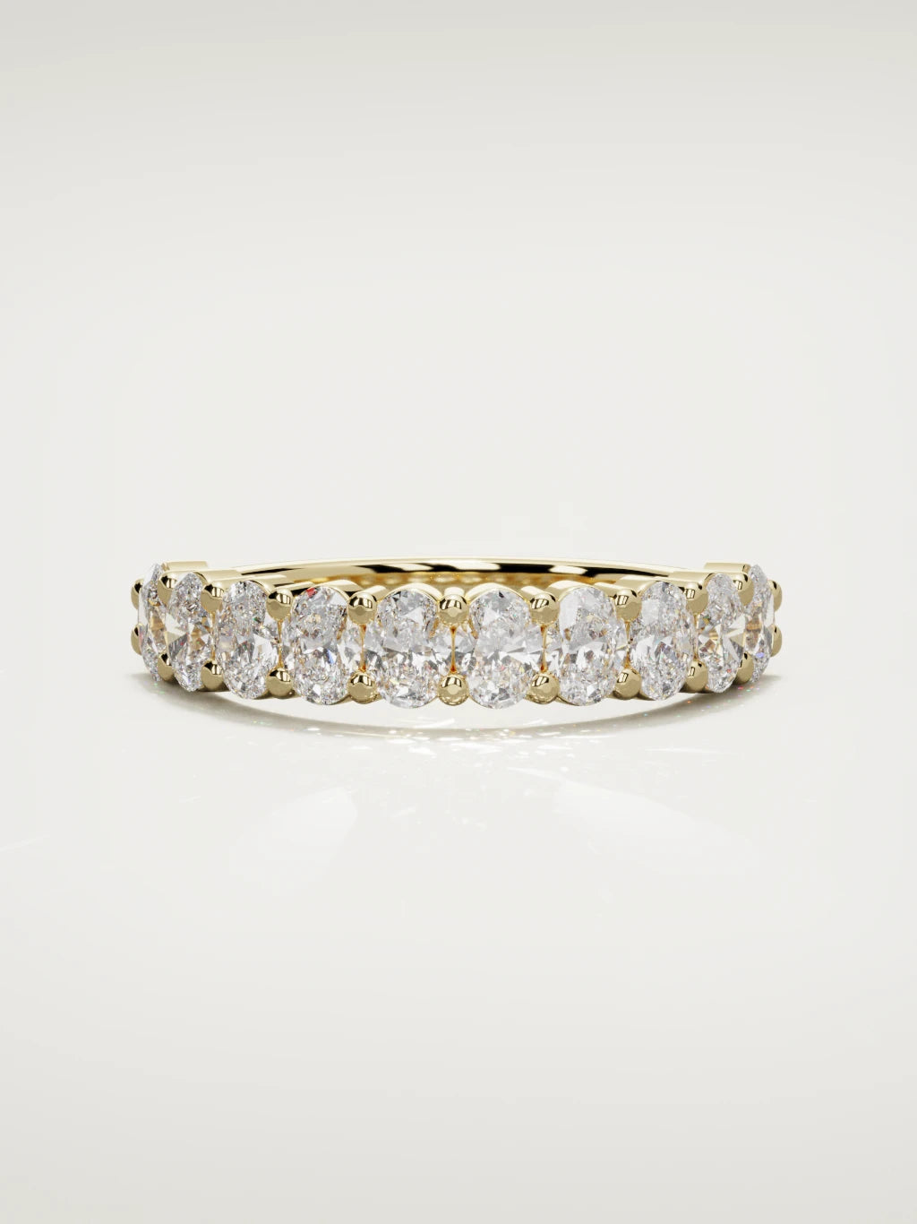The Musa north-south oval half eternity band in 14K yellow gold, front view
